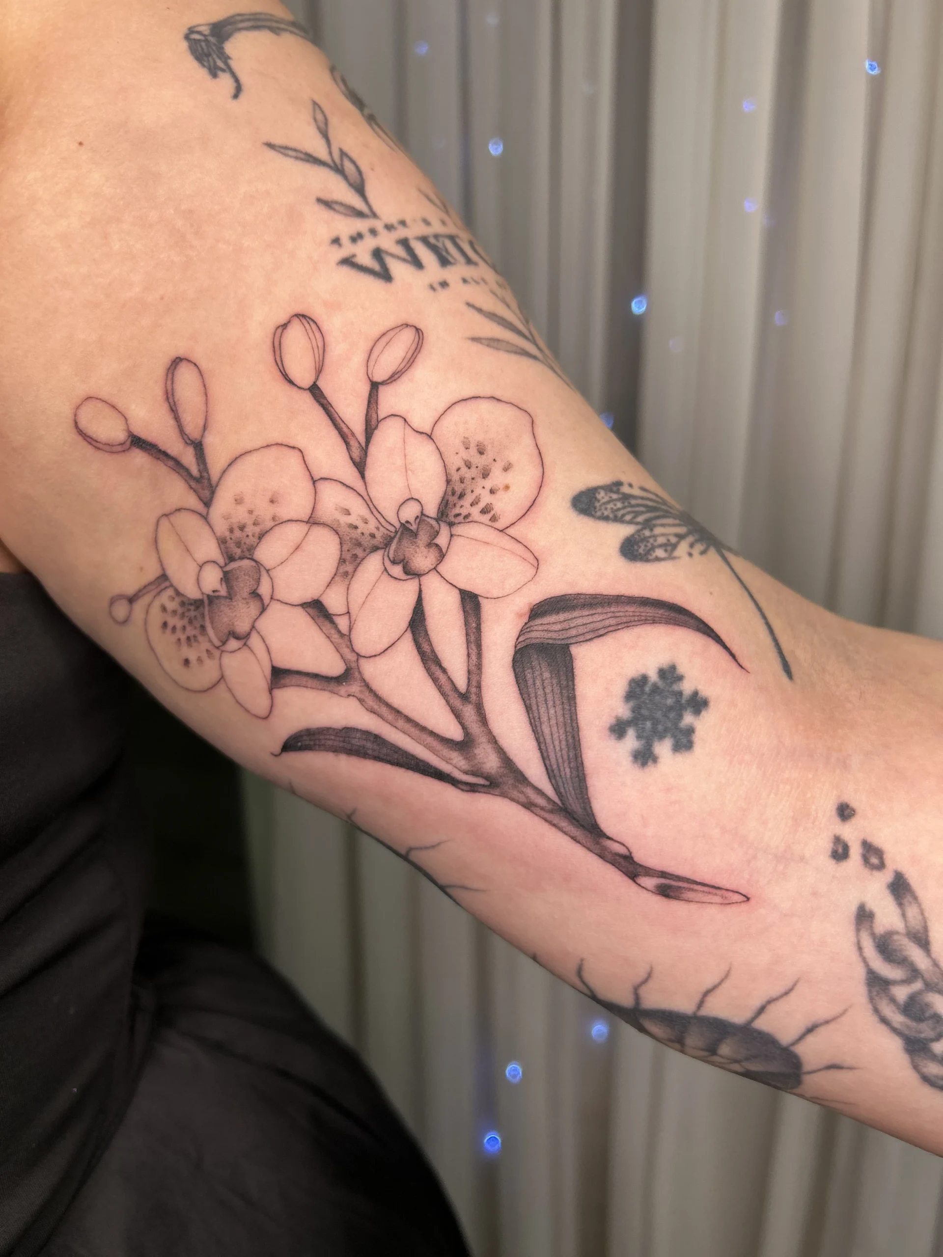 Micro realism floral tattoo at XOXO Dublin