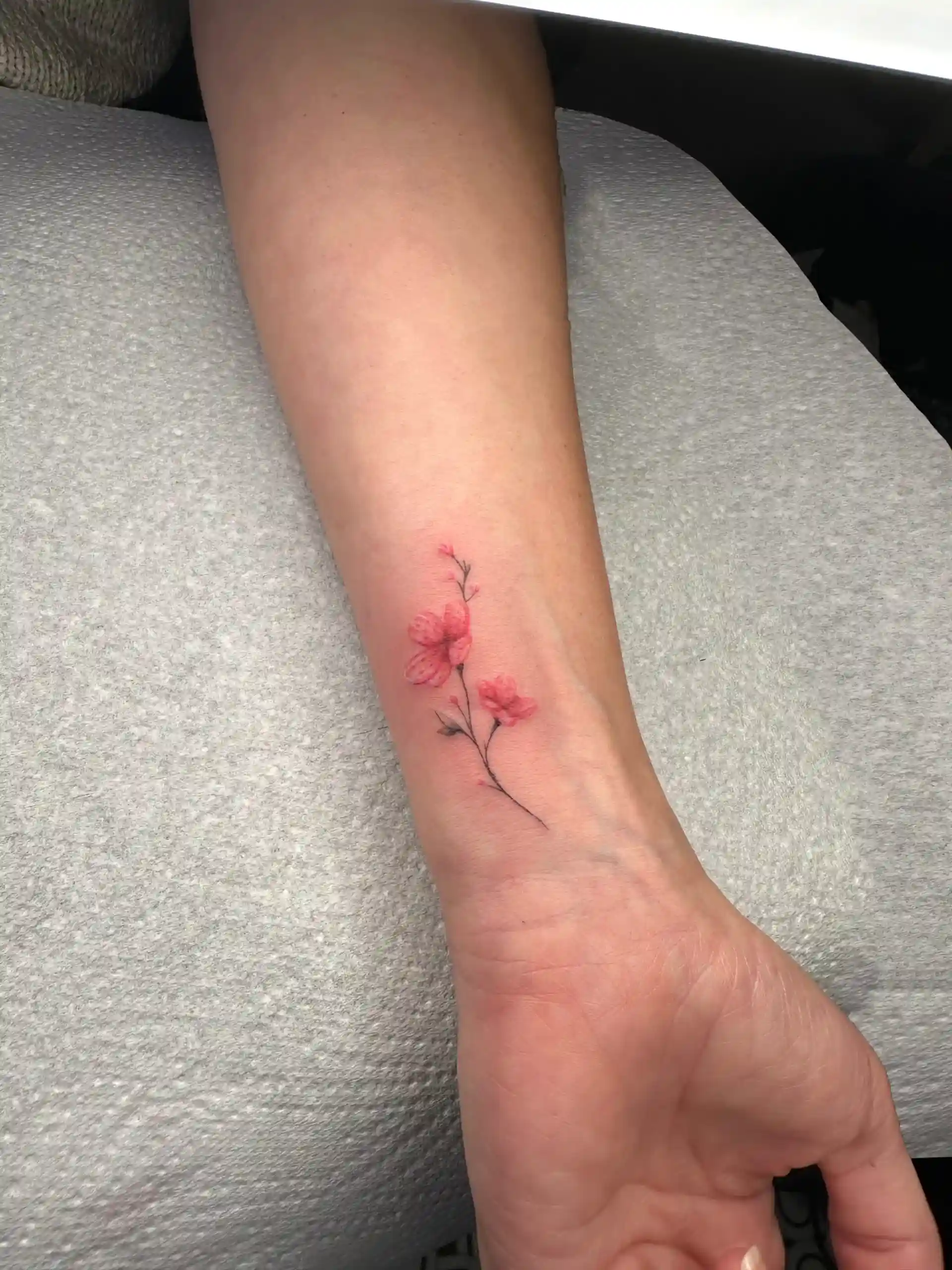 Vibrant color realism floral tattoo.