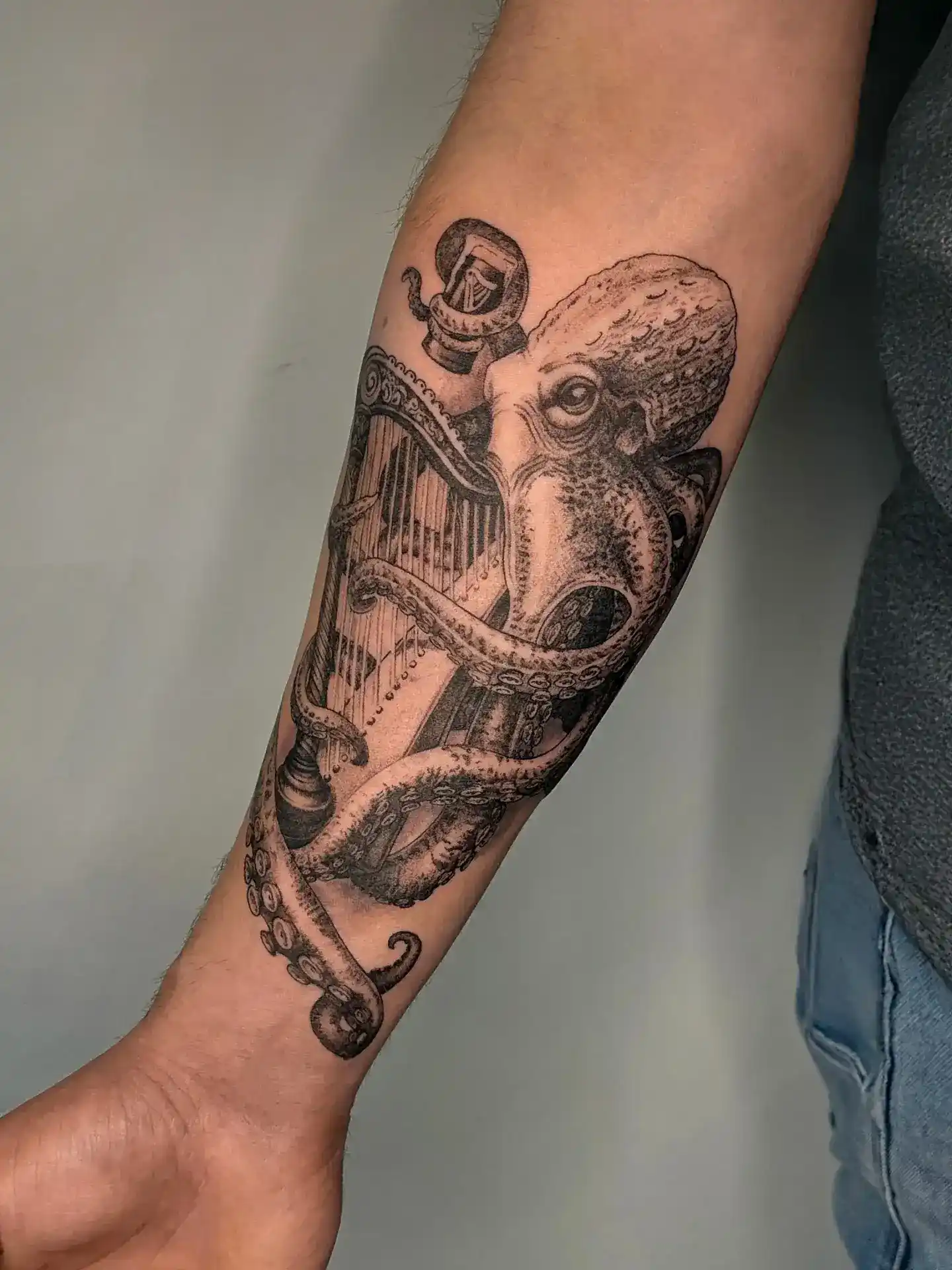 Blackwork octopus and harp tattoo by Gabriel Vendra, XOXO Tattoo Studio Dublin