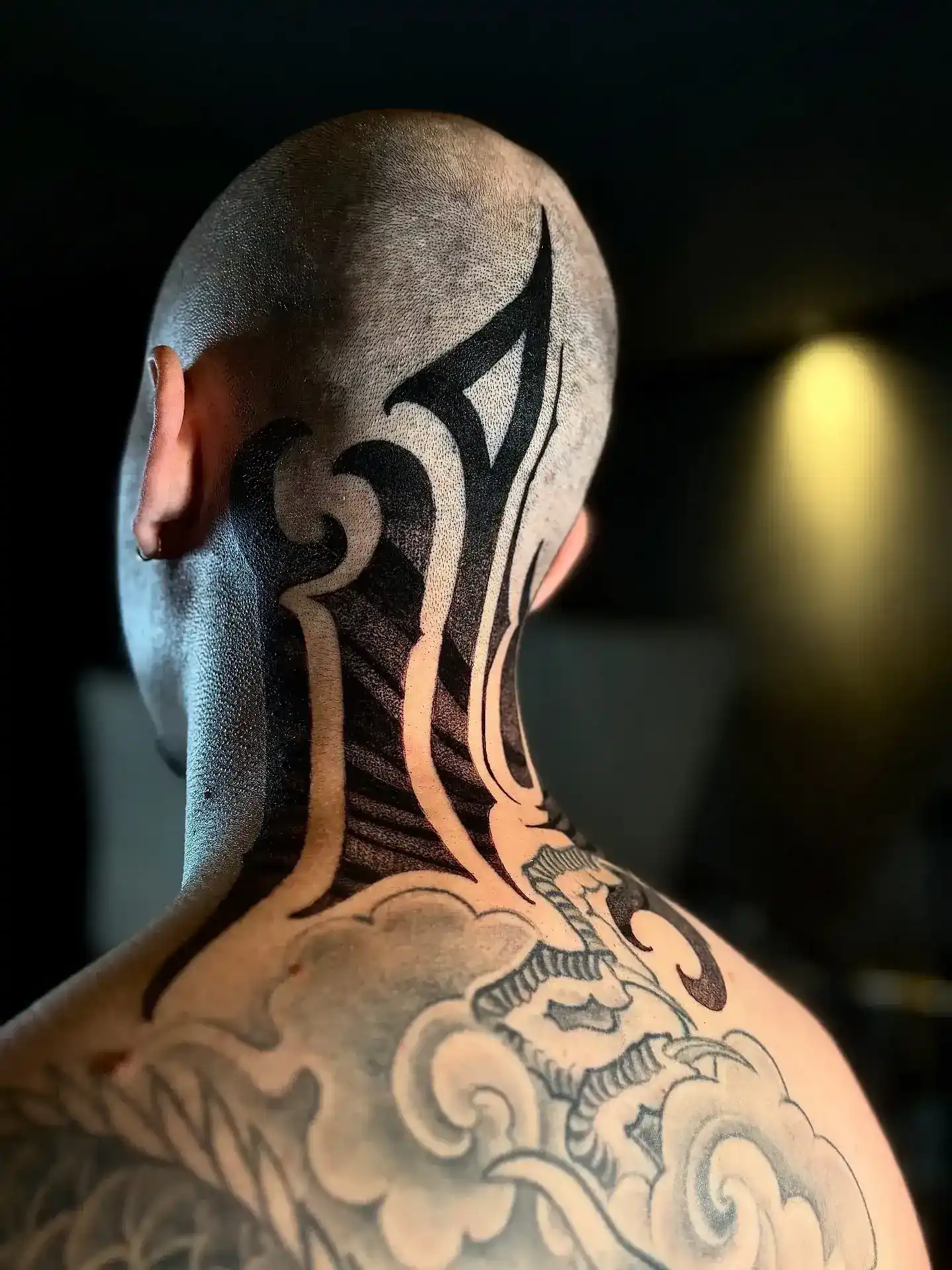 Blackwork tribal tattoo on head and neck by Gabriel Vendra at XOXO Dublin