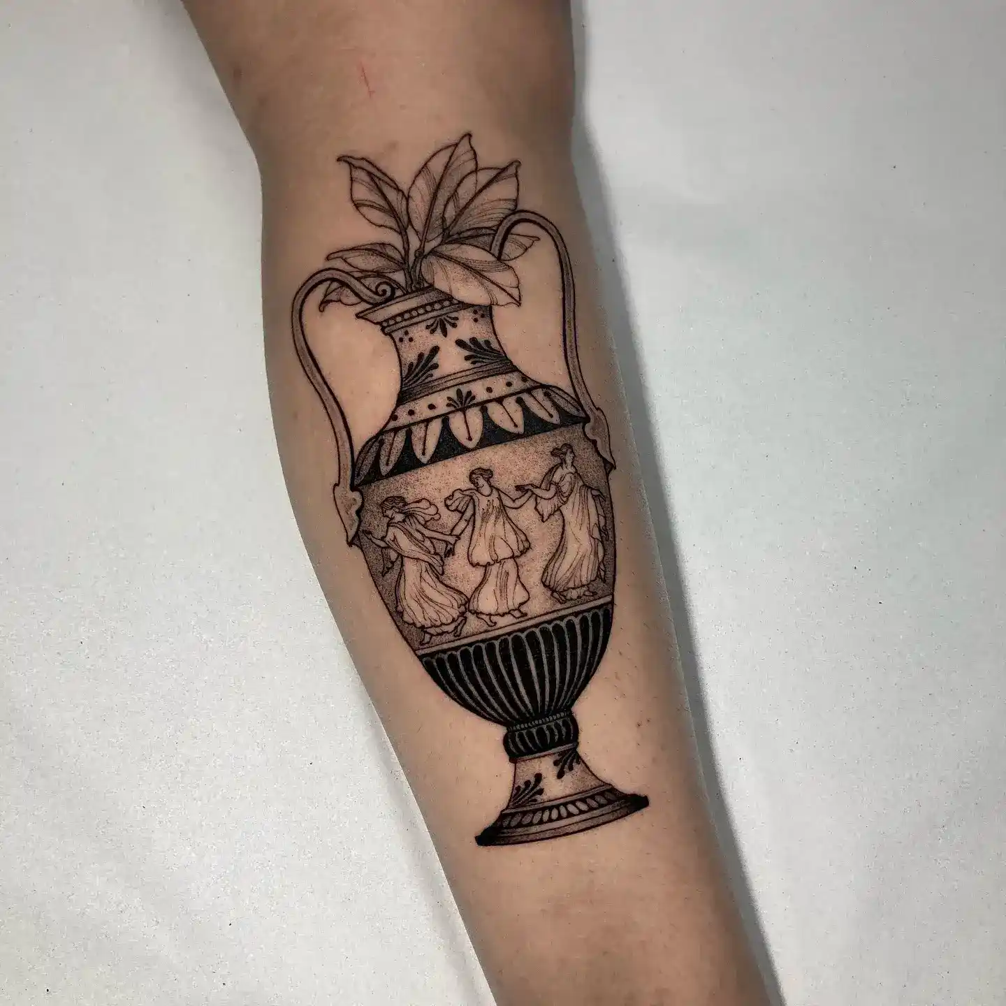 Fine-line Grecian vase tattoo by Gabriel Vendra, XOXO Dublin
