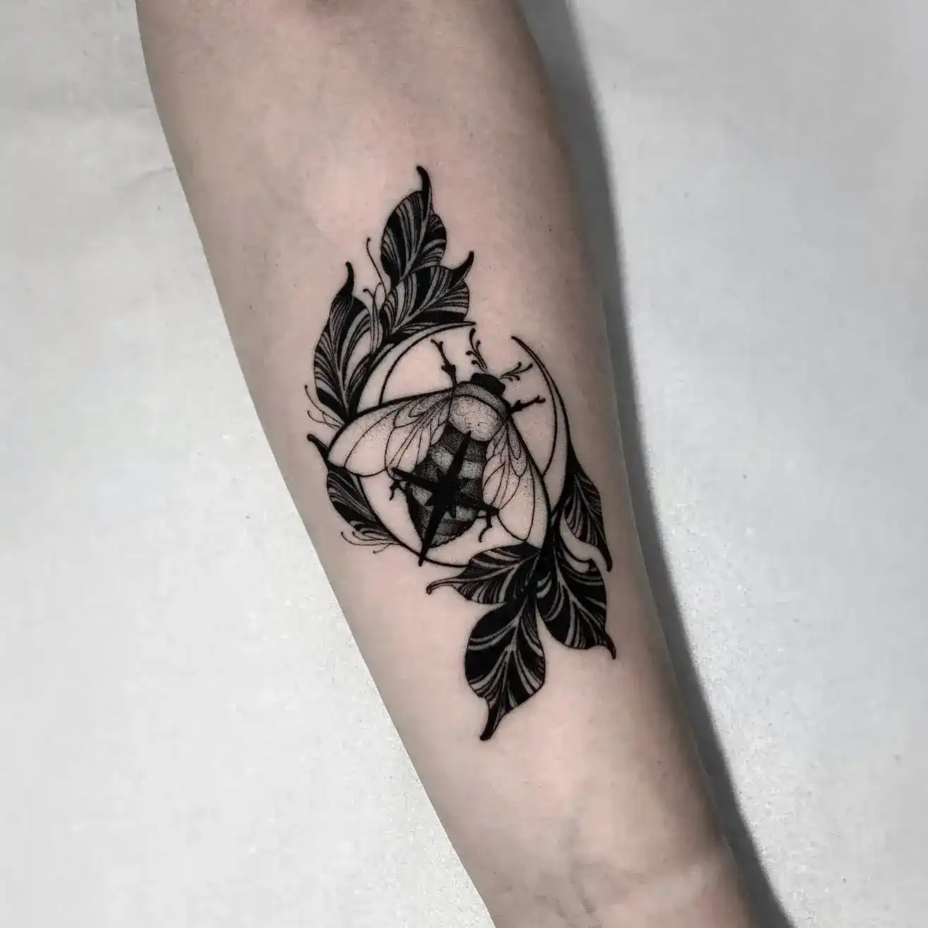 Fine-line moth and compass tattoo by Gabriel Vendra, XOXO Dublin