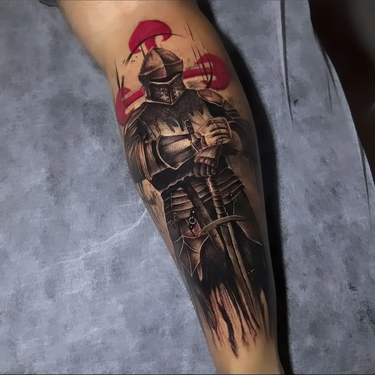 Knight in armour calf tattoo with red accents by Paulo Rodrigues at XOXO Dublin